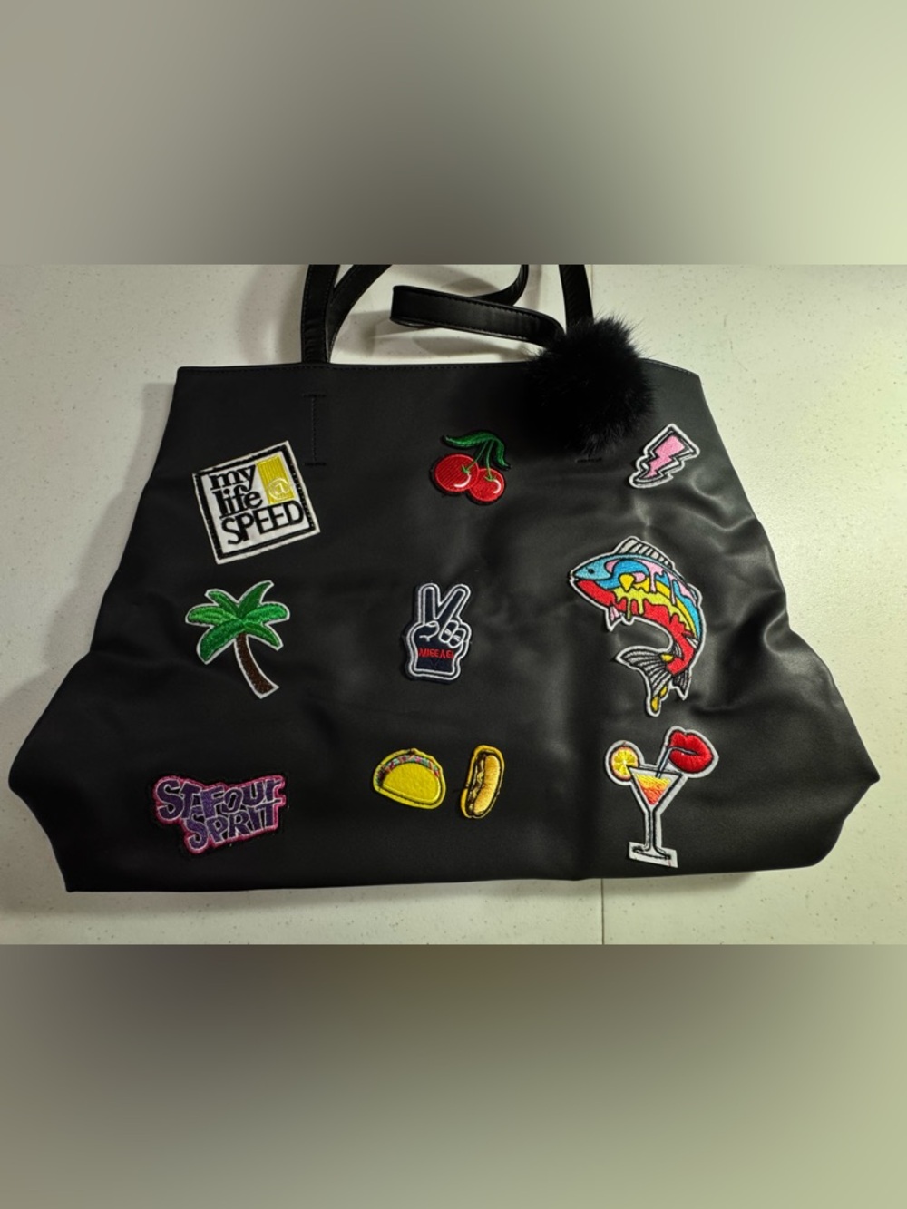 Patchwork Graphic Black Faux Leather Tote Bag with Faux Fur Pom 17X12X4 in. NWOT